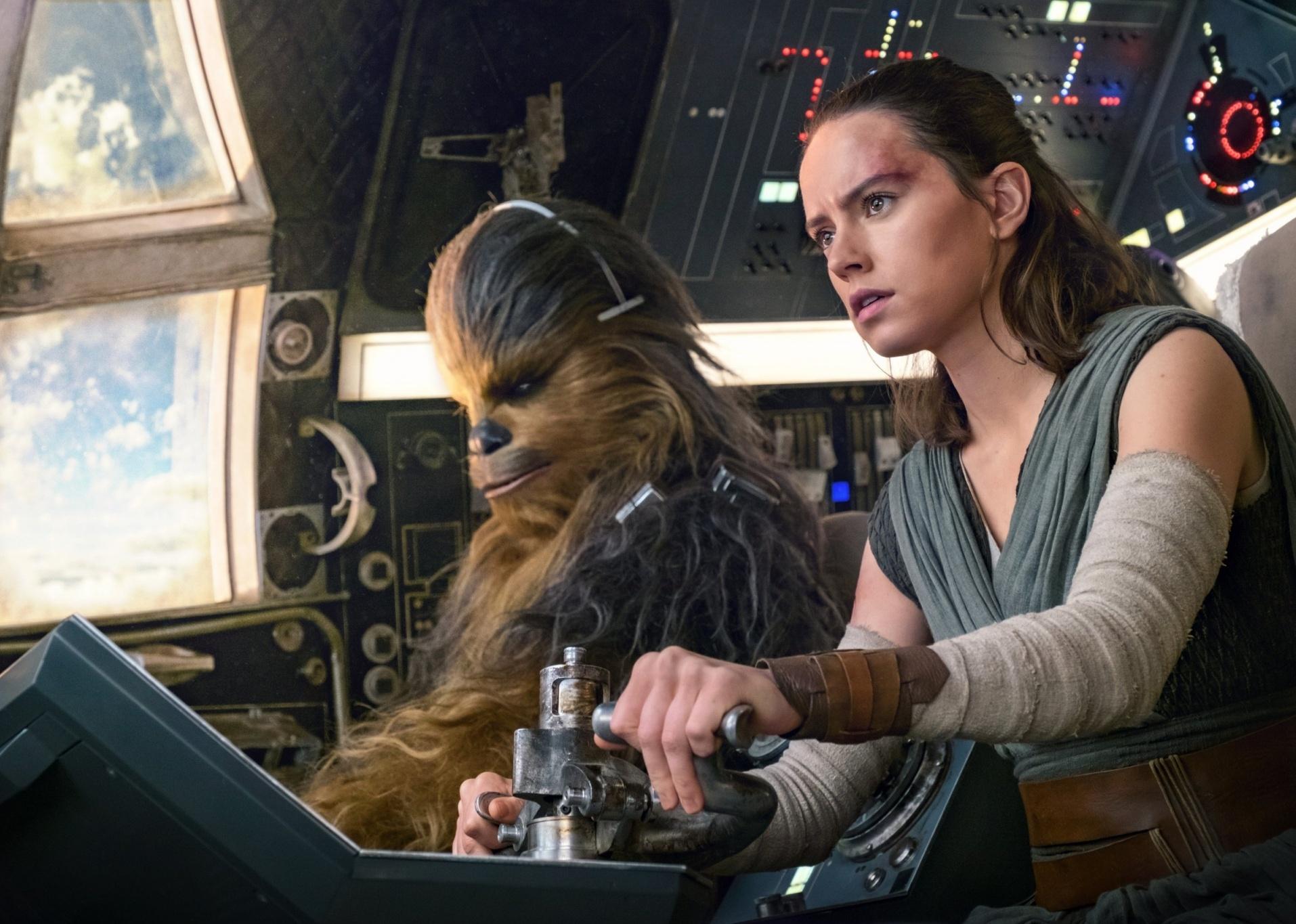 Daisy Ridley flying a space ship with a furry creature as the co-pilot.