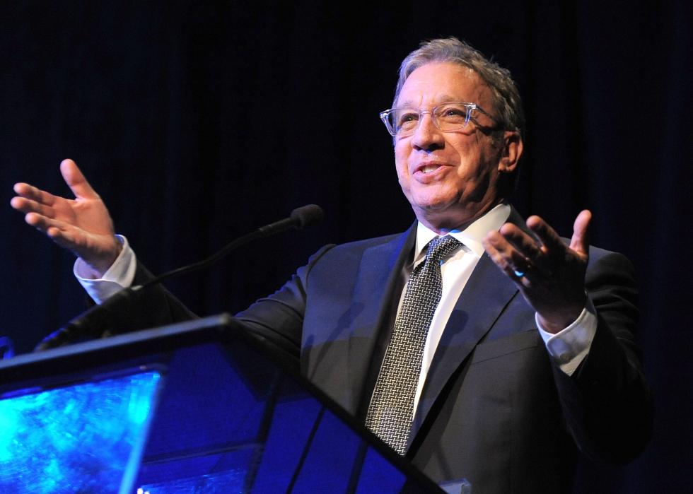 Tim Allen speaking at the podium of an awards ceremony in 2013.