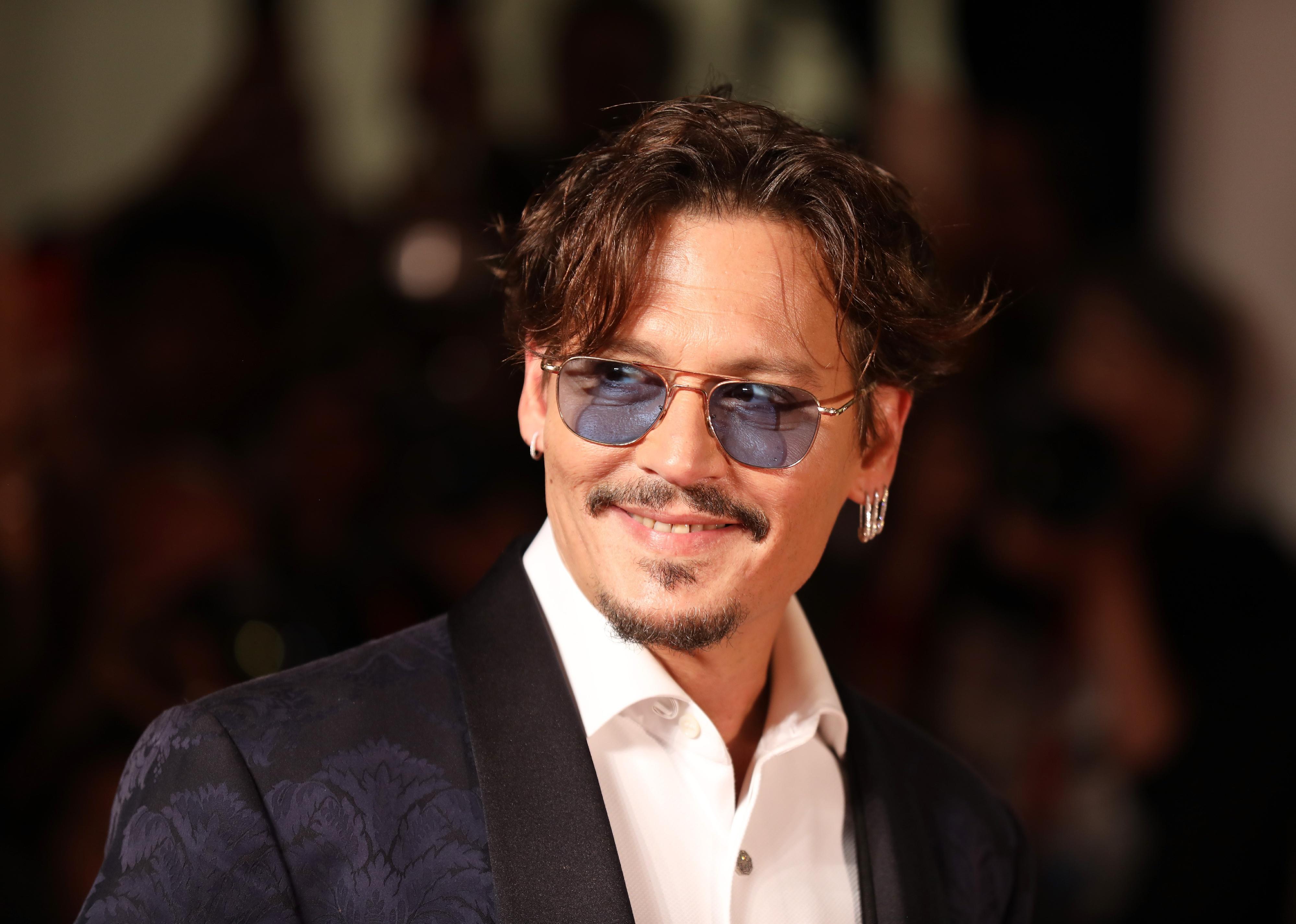 Johnny Depp in a black jacquard blazer.