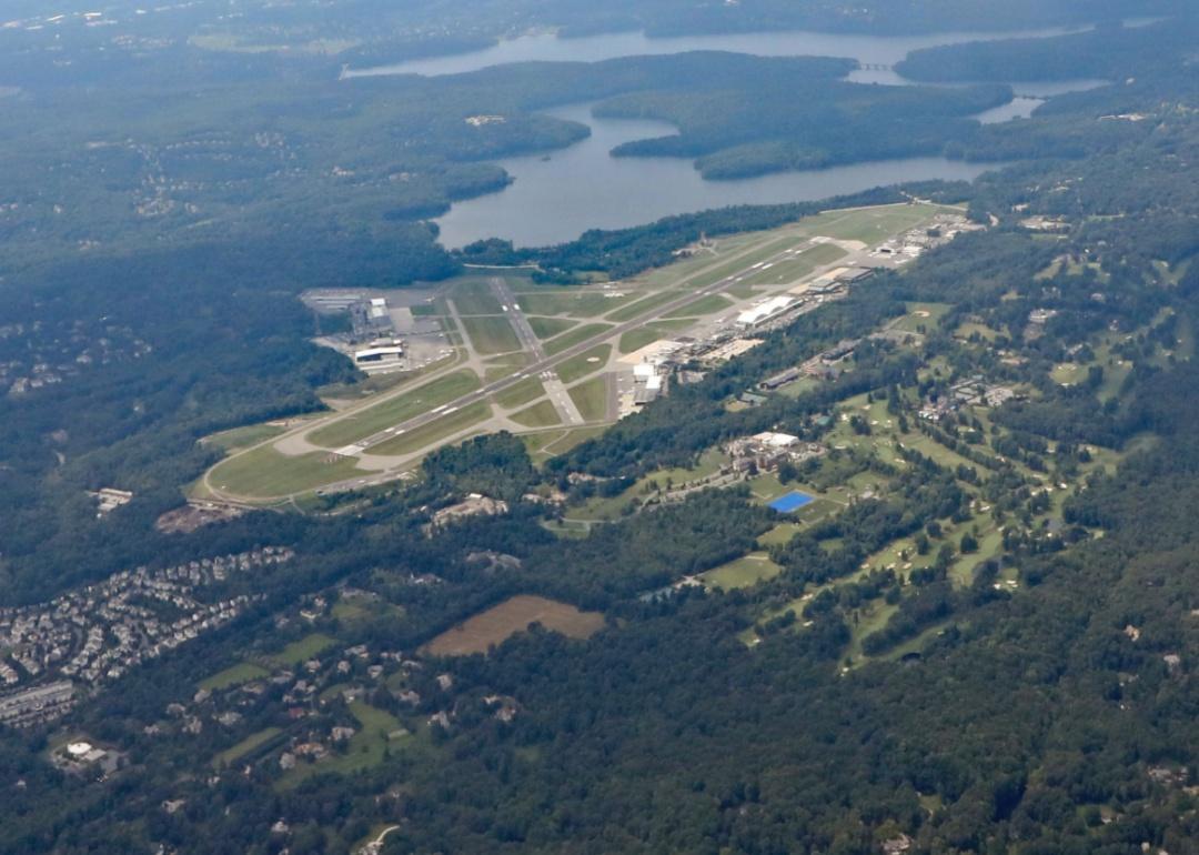 Aerial view of the Westchester County airport surrounded by trees and lakes.