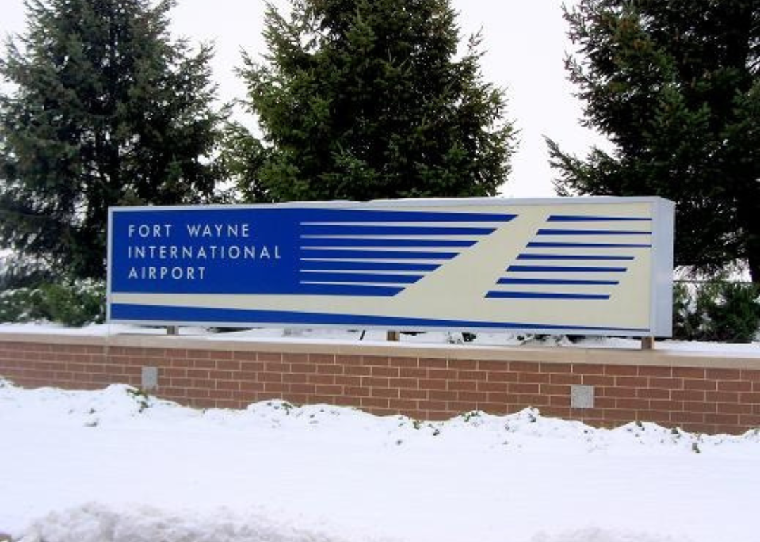 A blue entrance sign to Fort Wayne International Airport.