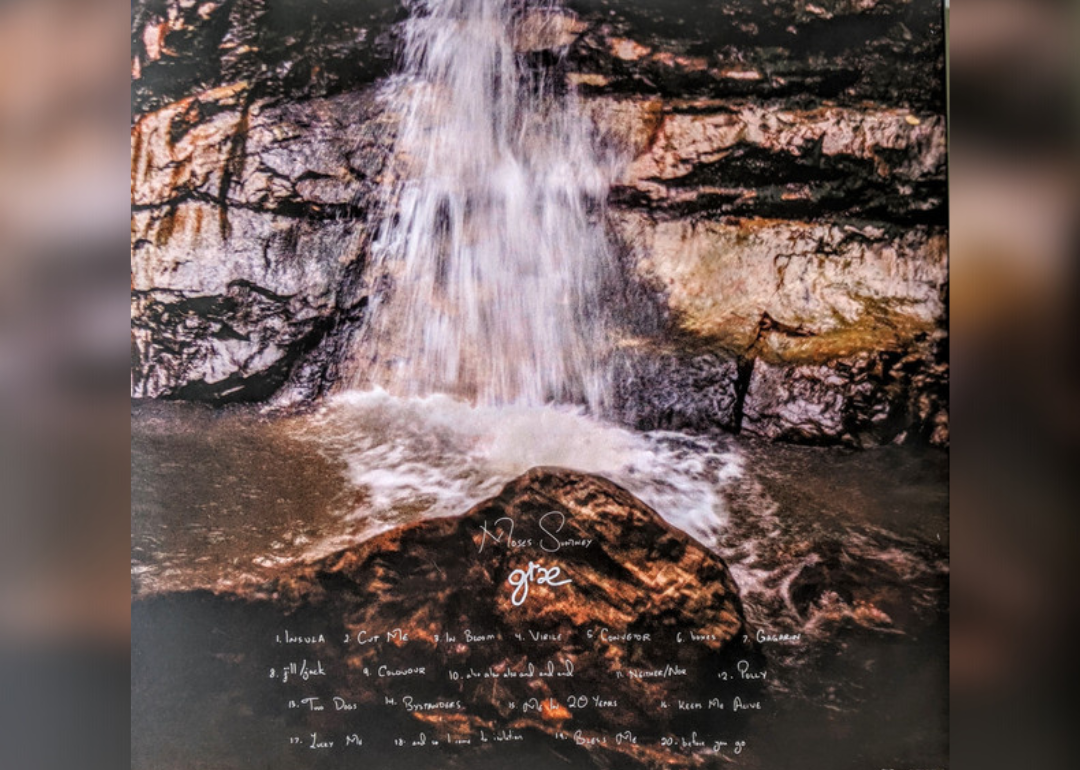 A waterfall with the songs on the album listed in white.