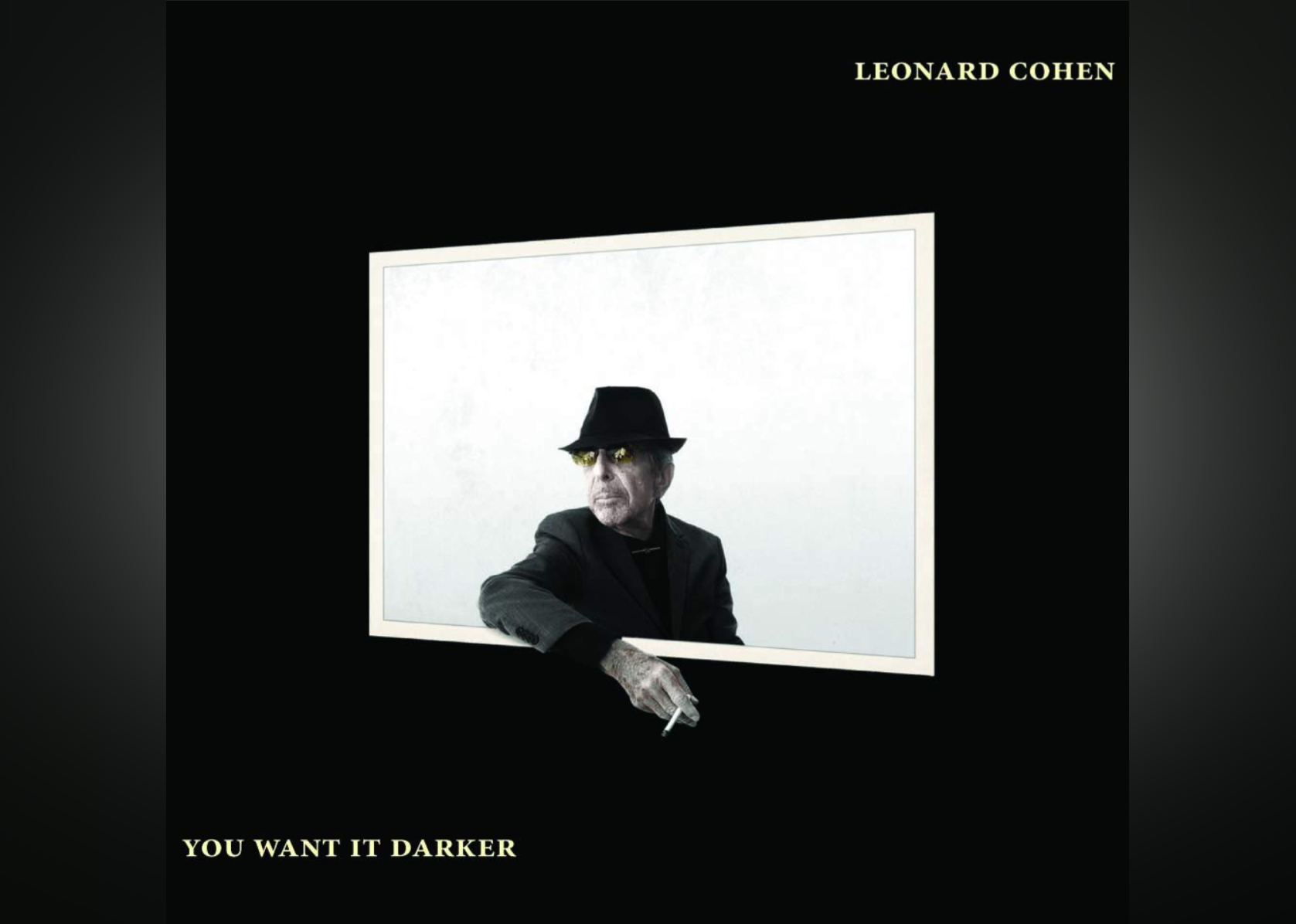 Leonard Cohen in all black and wearing a hat with his arm out of a window holding a cigarette.