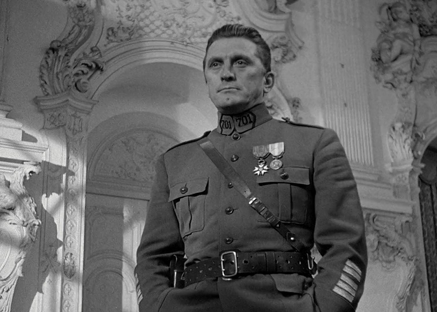 Kirk Douglas in a military uniform in a beautiful ornate historic room.