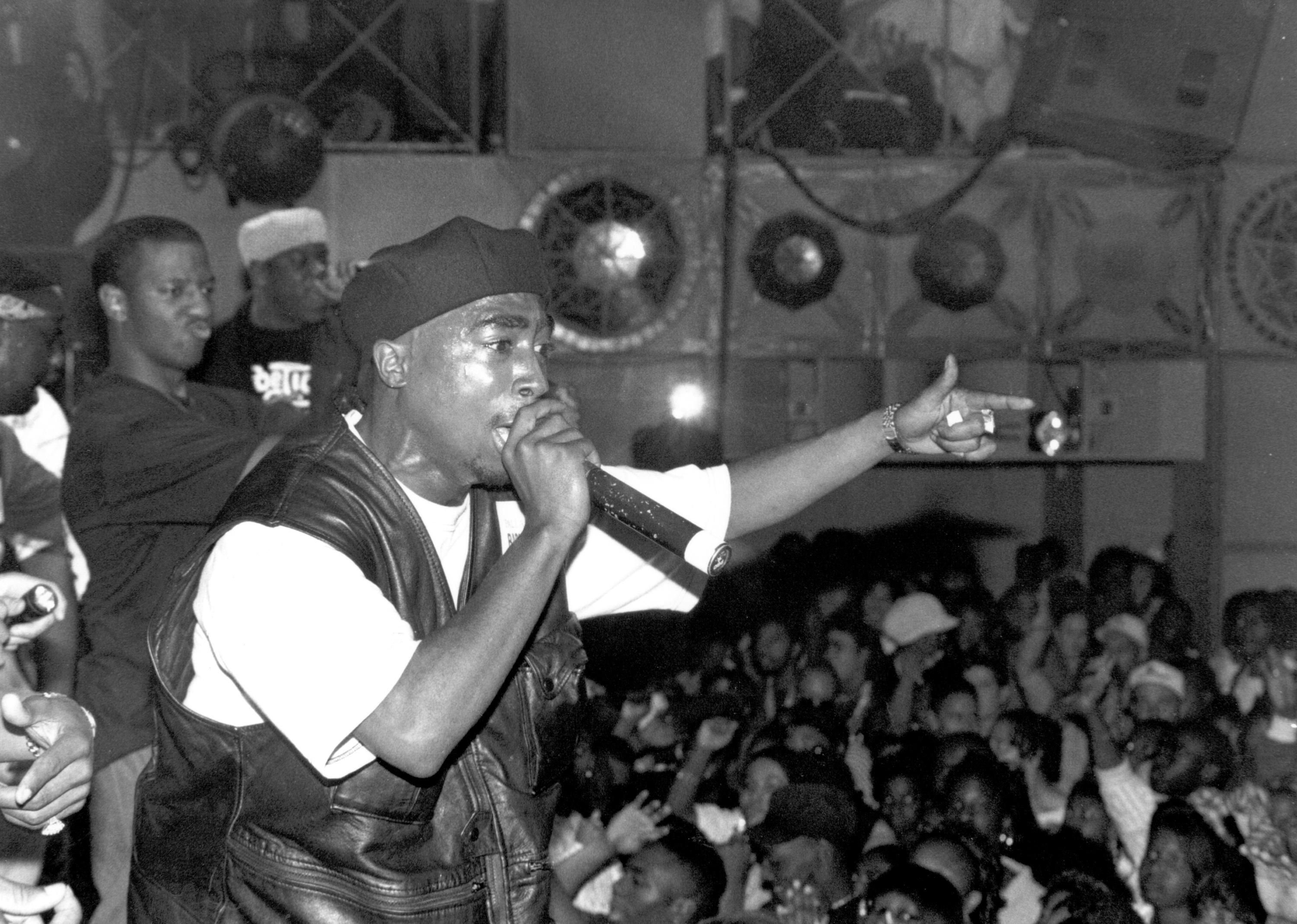 Tupac performing to a large crowd.