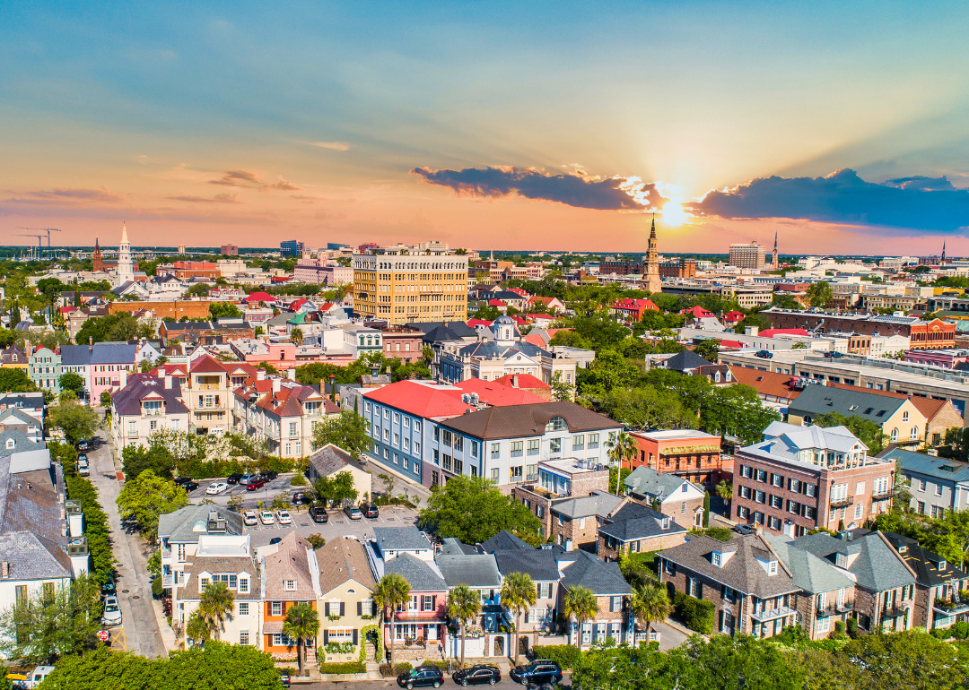 An aerial view of beautiful homes and downtown Charleston, SC. against the sunset.