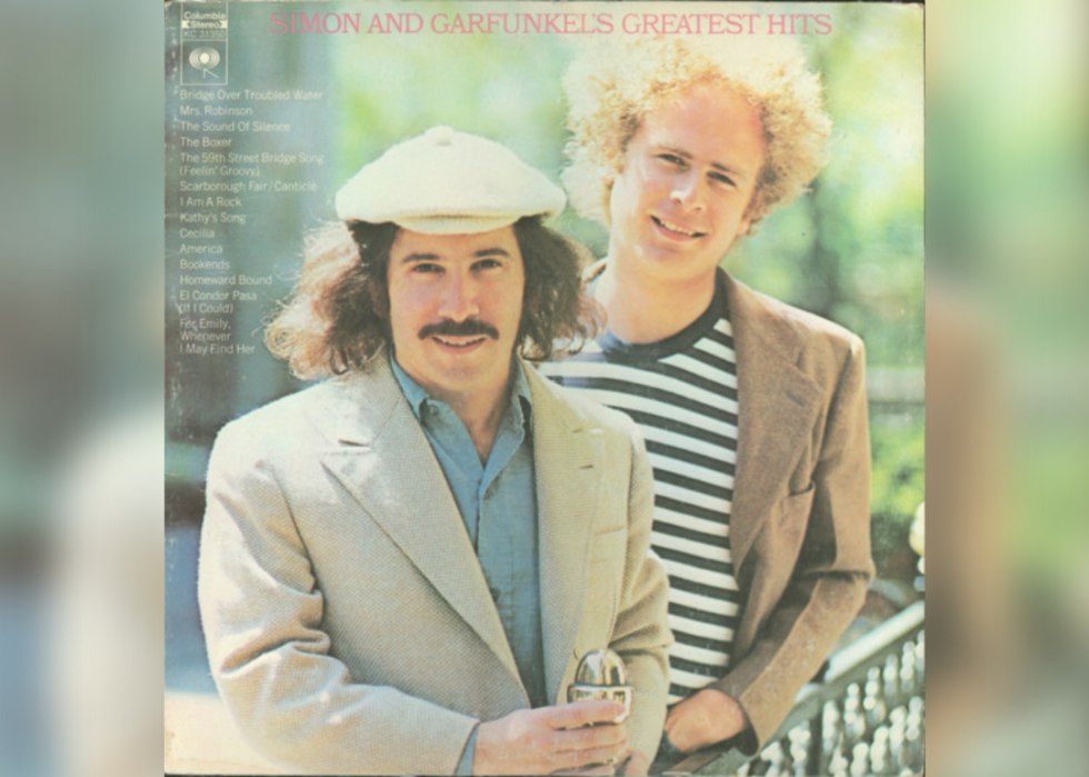 Simon and Garfunkel smiling.
