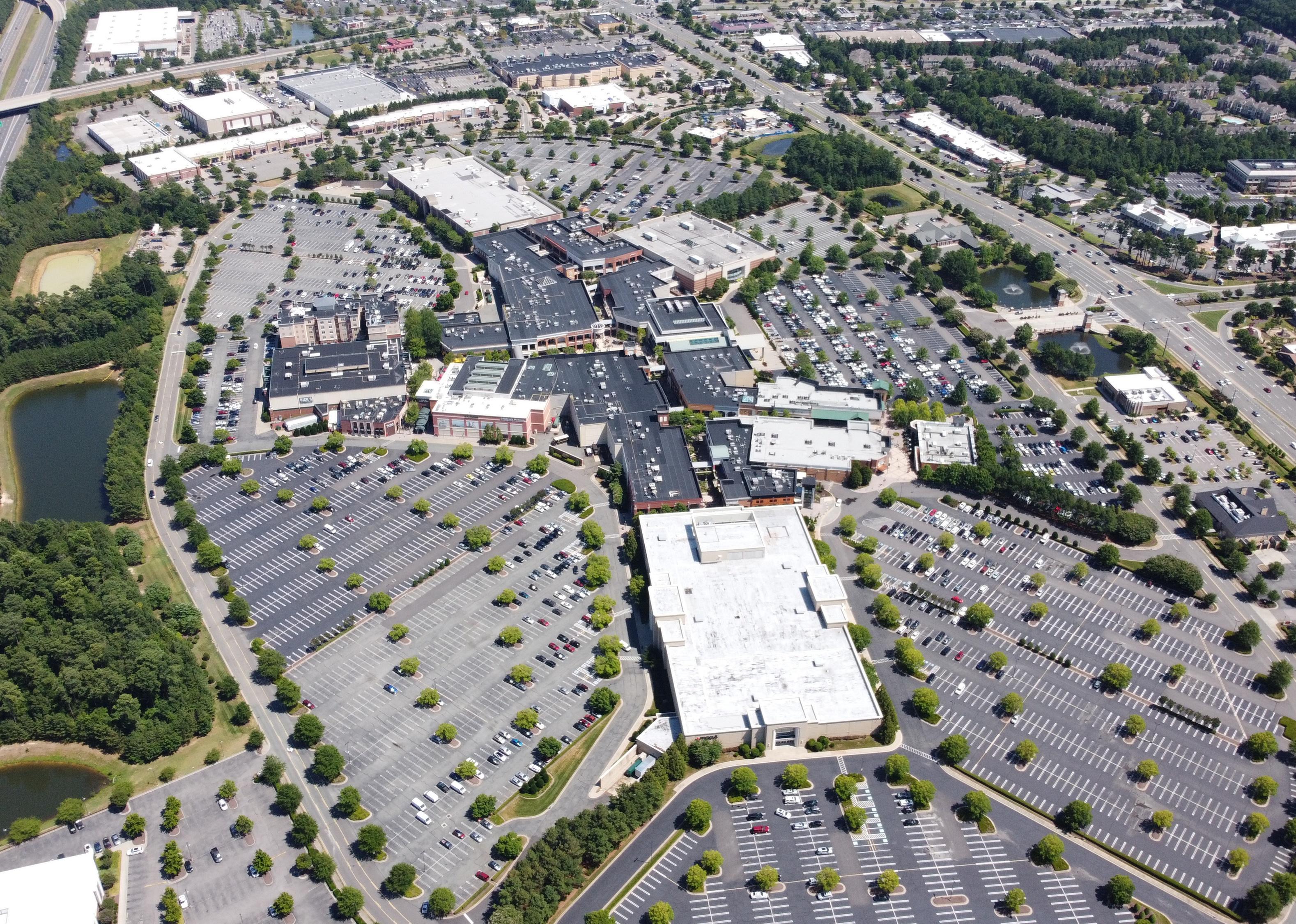 An aerial view of buildings surrounded by parking lots.