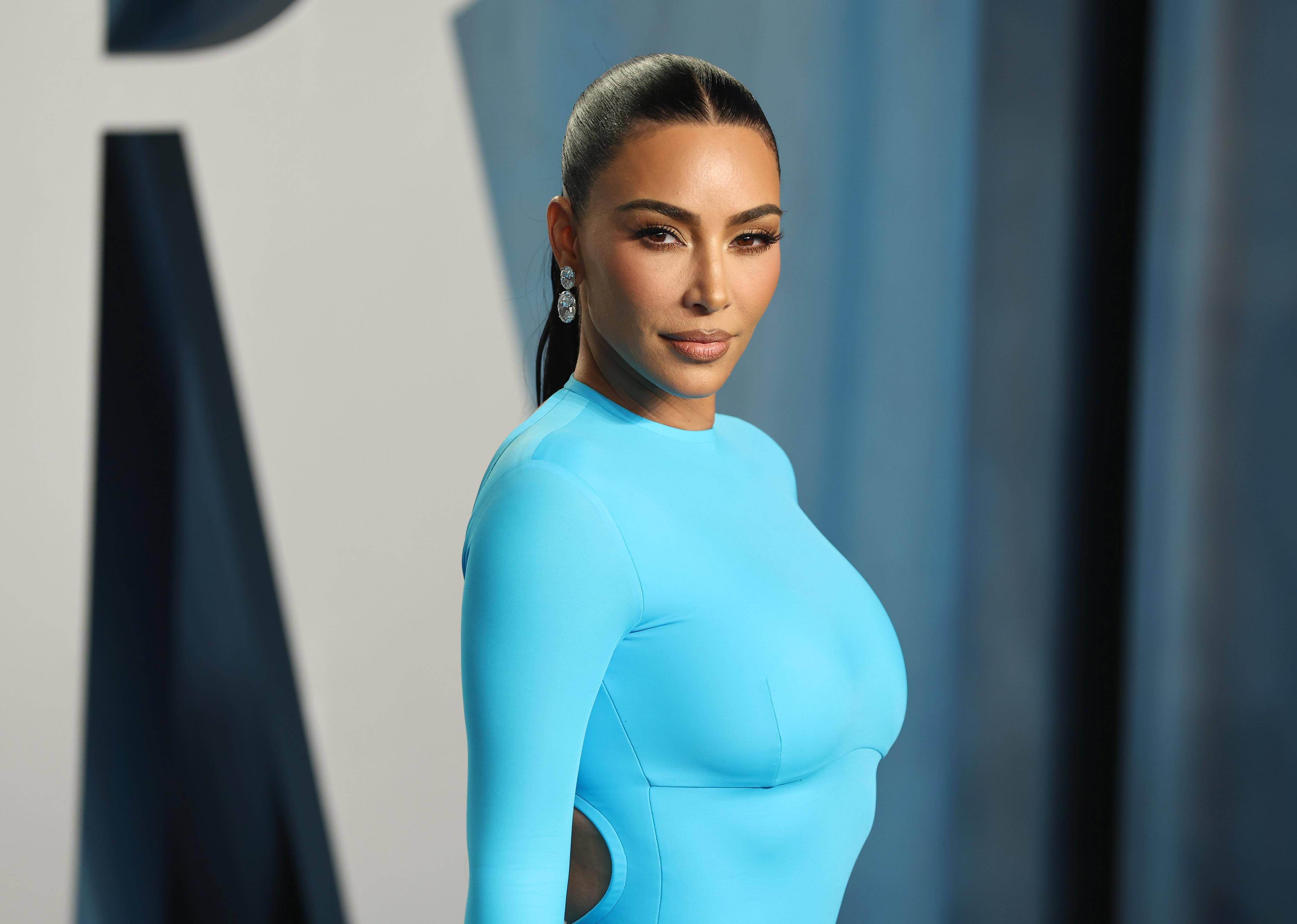 Kim Kardashian in a tight light blue outfit.