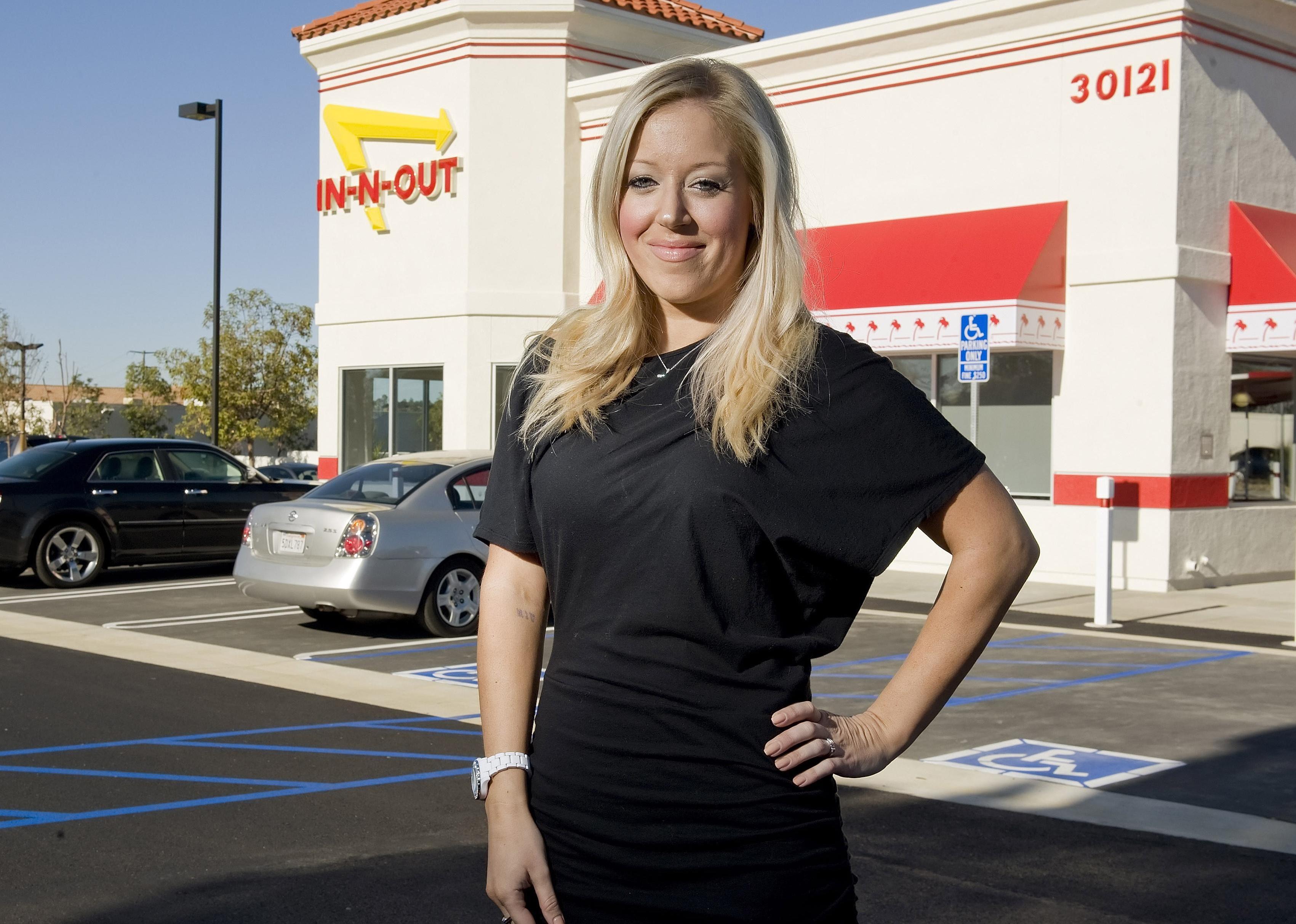 Lynsi Snyder in front of an In-N-Out Burger restaurant.