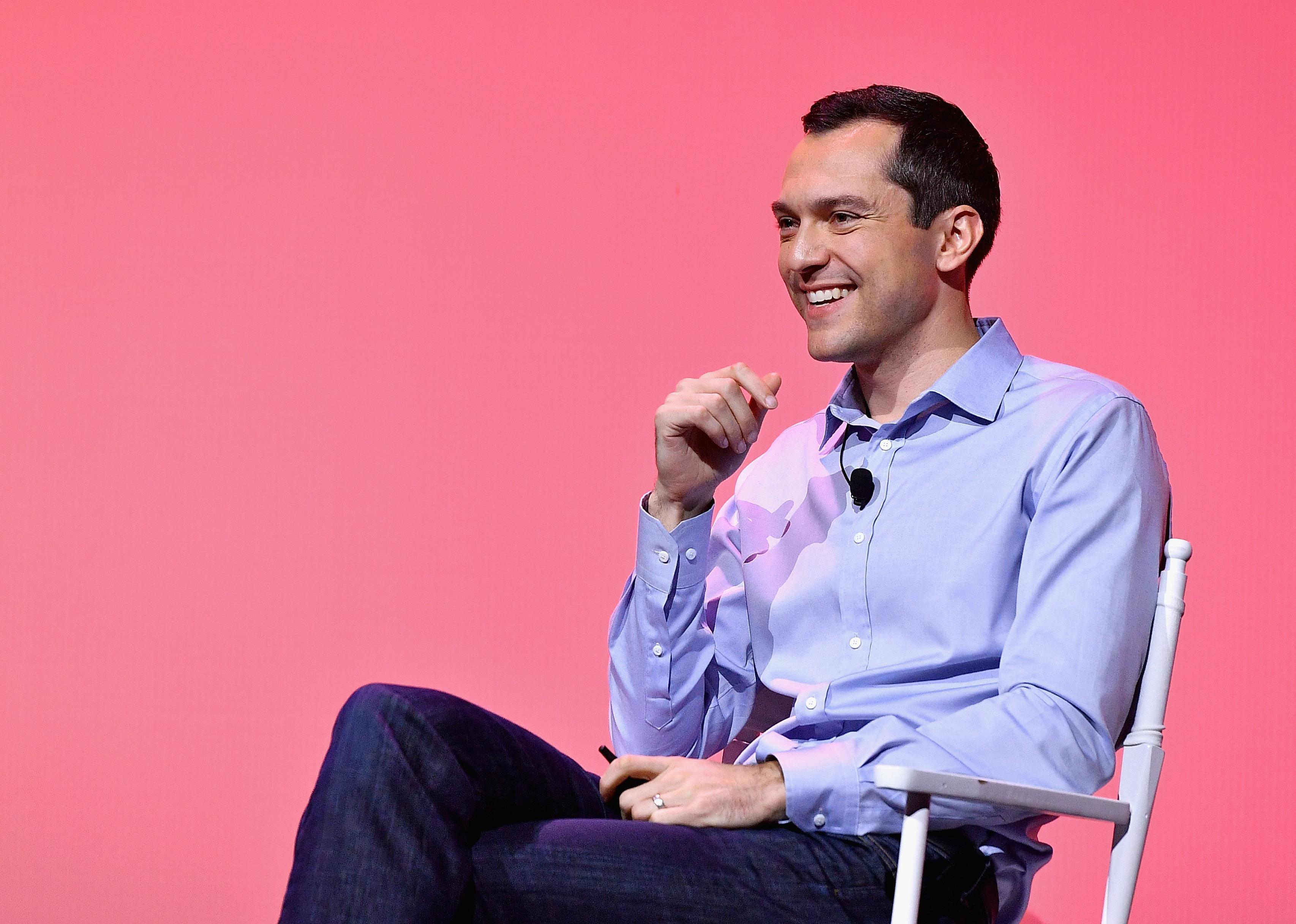 Nathan Blecharczyk in front of a pink background.