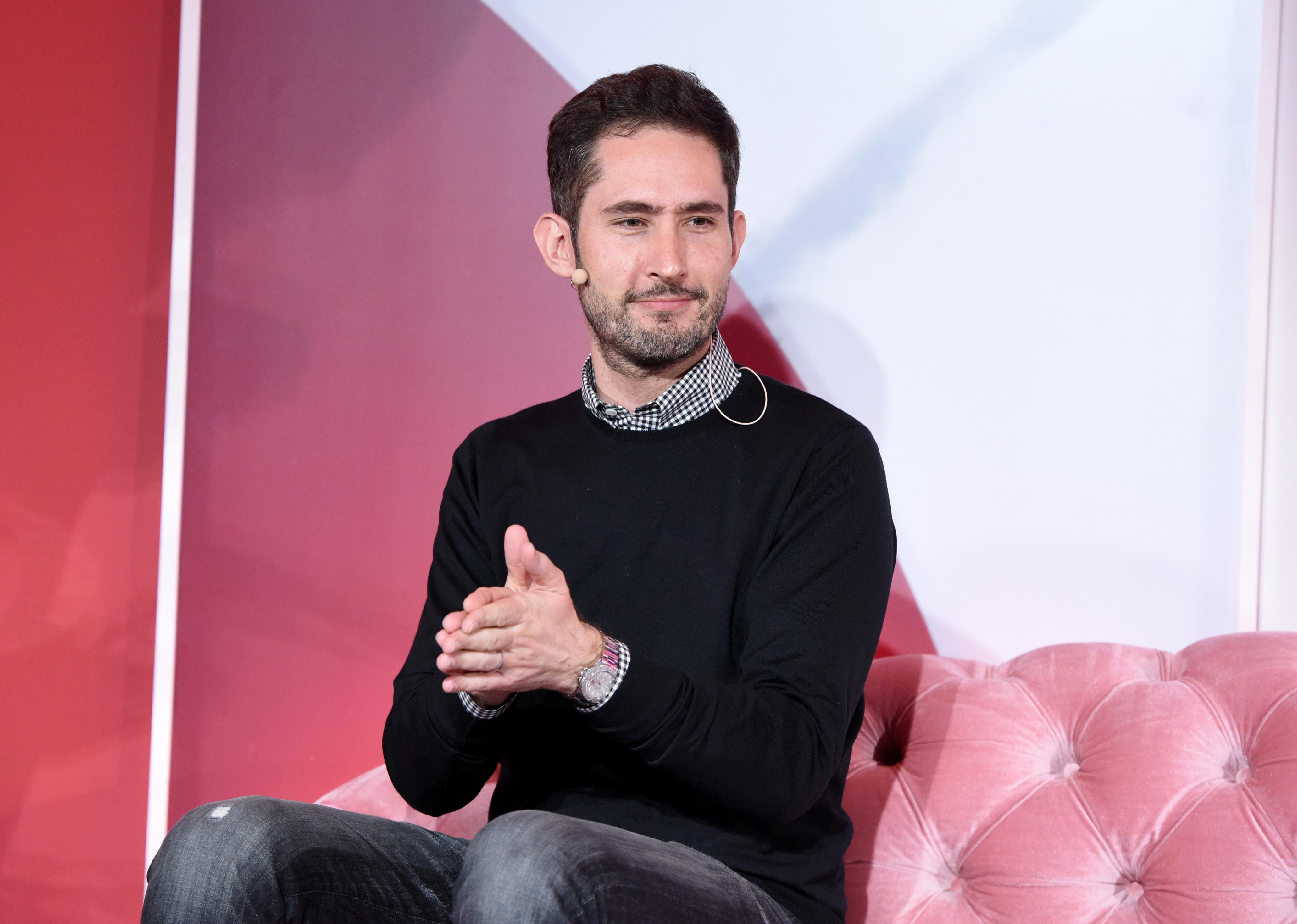Kevin Systrom sitting on a pink velvet couch.