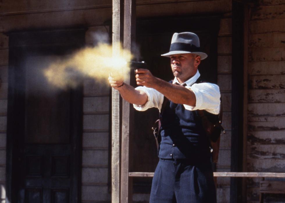 Bruce Willis fires pistols double fisted in a prohibition era ghost town.