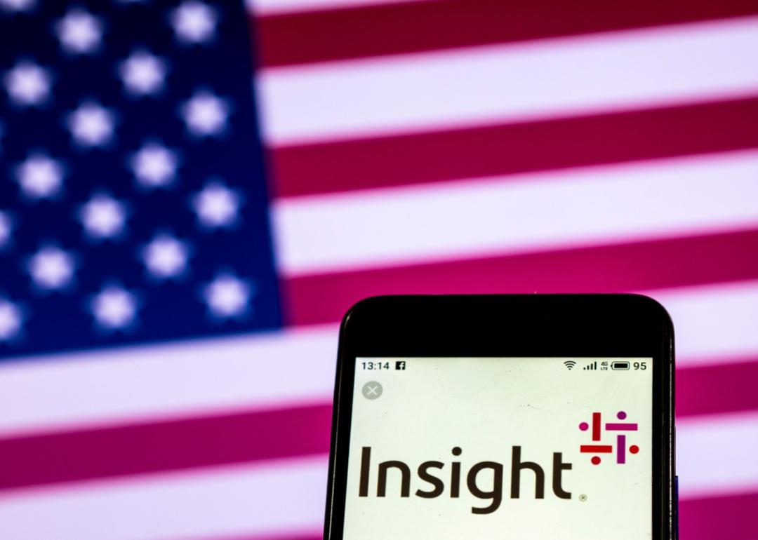 The Insight logo on a phone in front of an American flag.