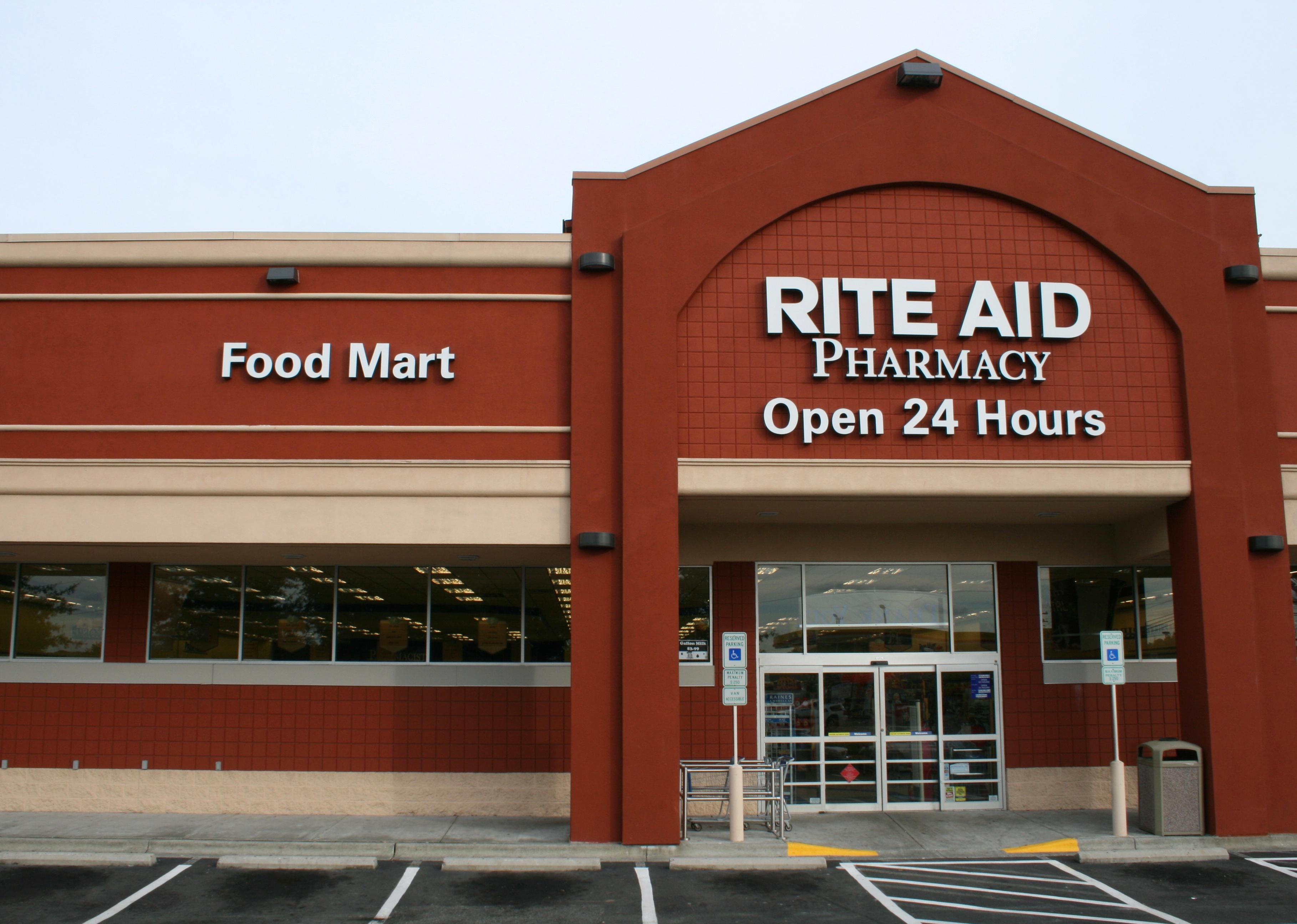 The exterior of a terra cotta colored Rite Aid store.
