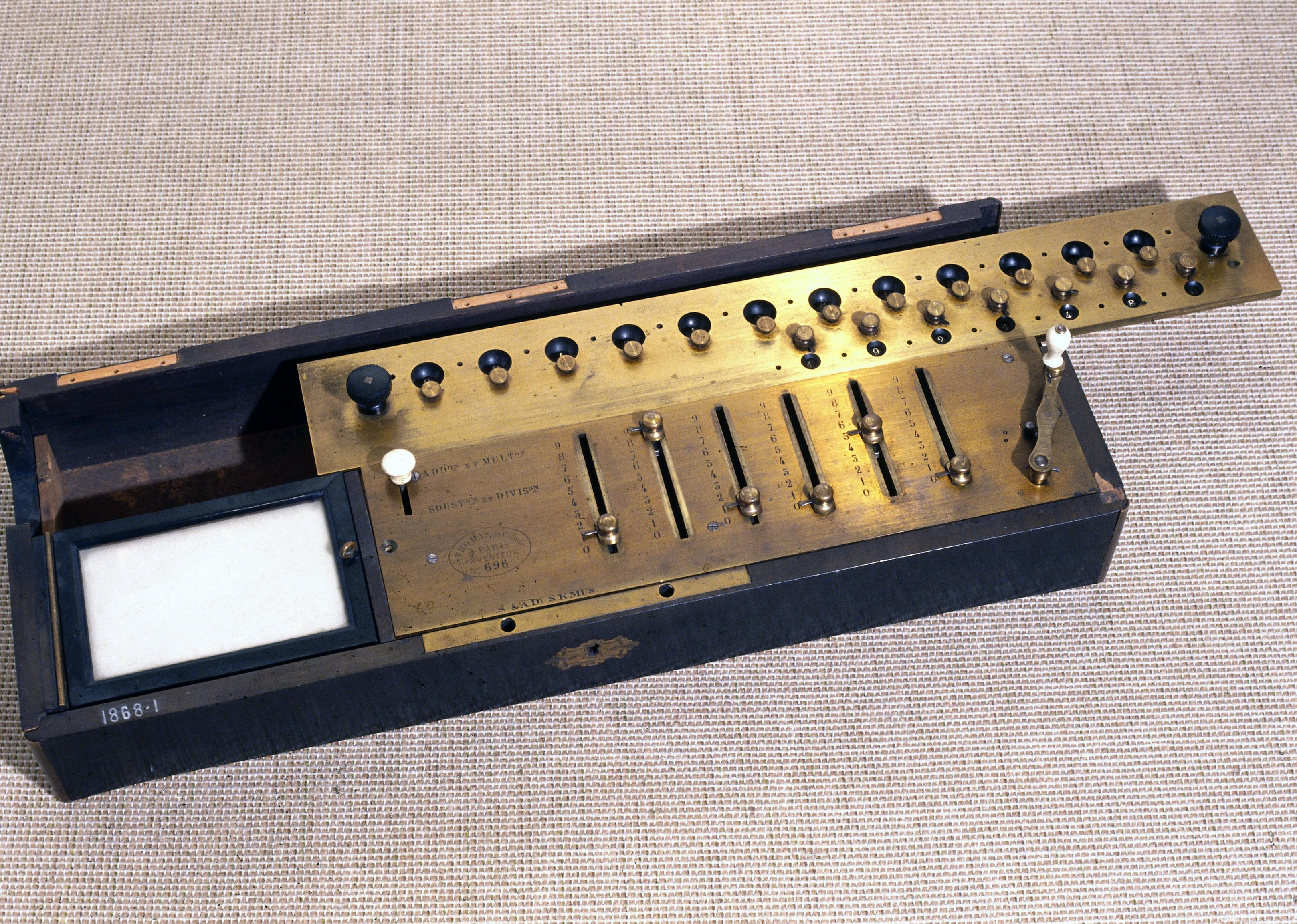 A rectangular wooden box with metal mechanisms.