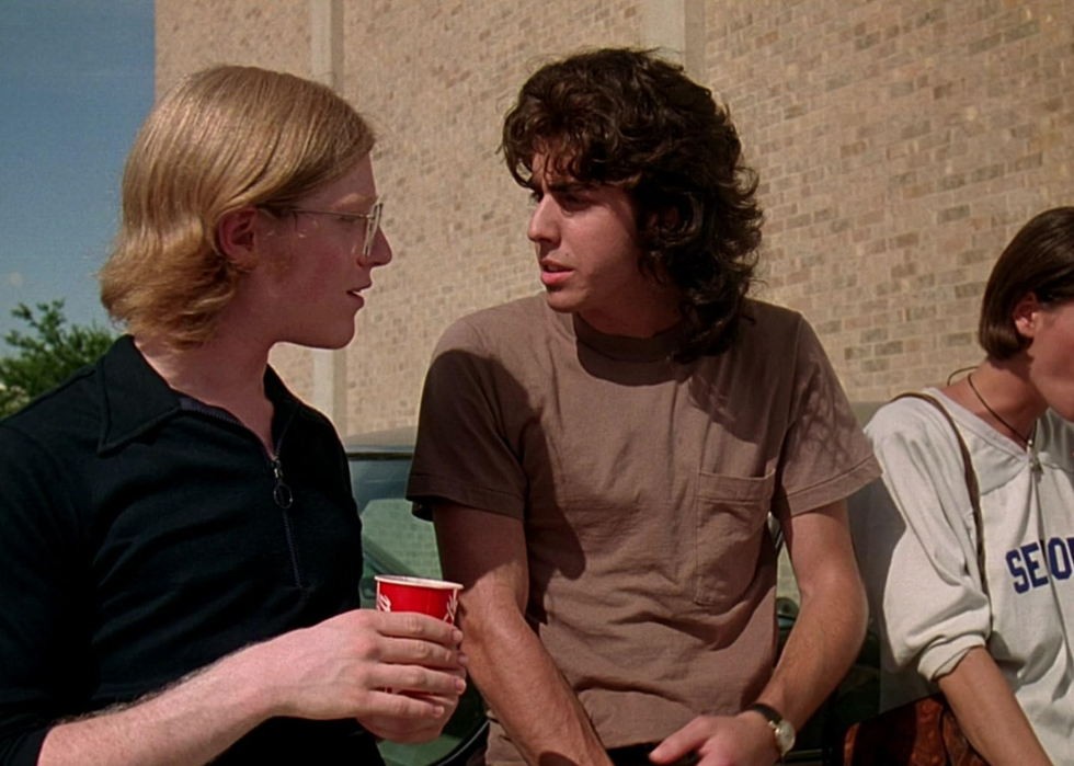 Anthony Rapp and Adam Goldberg talking outside in a scene from Dazed and Confused.