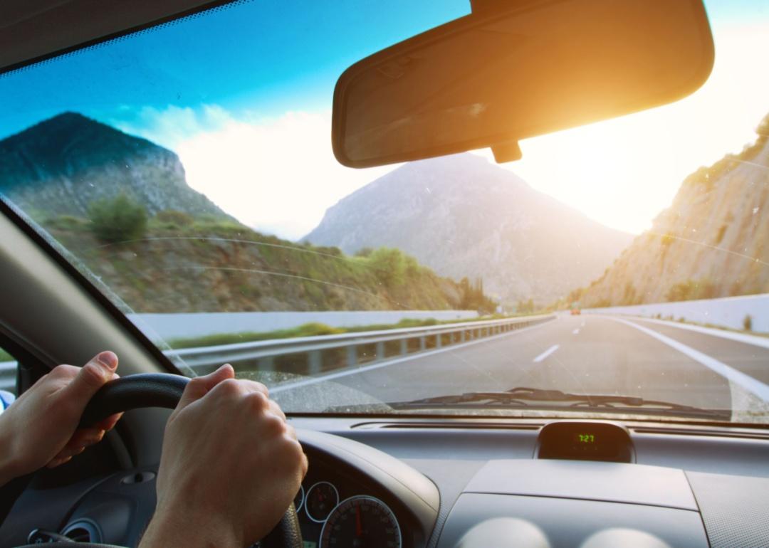 A person driving on a mountain road.