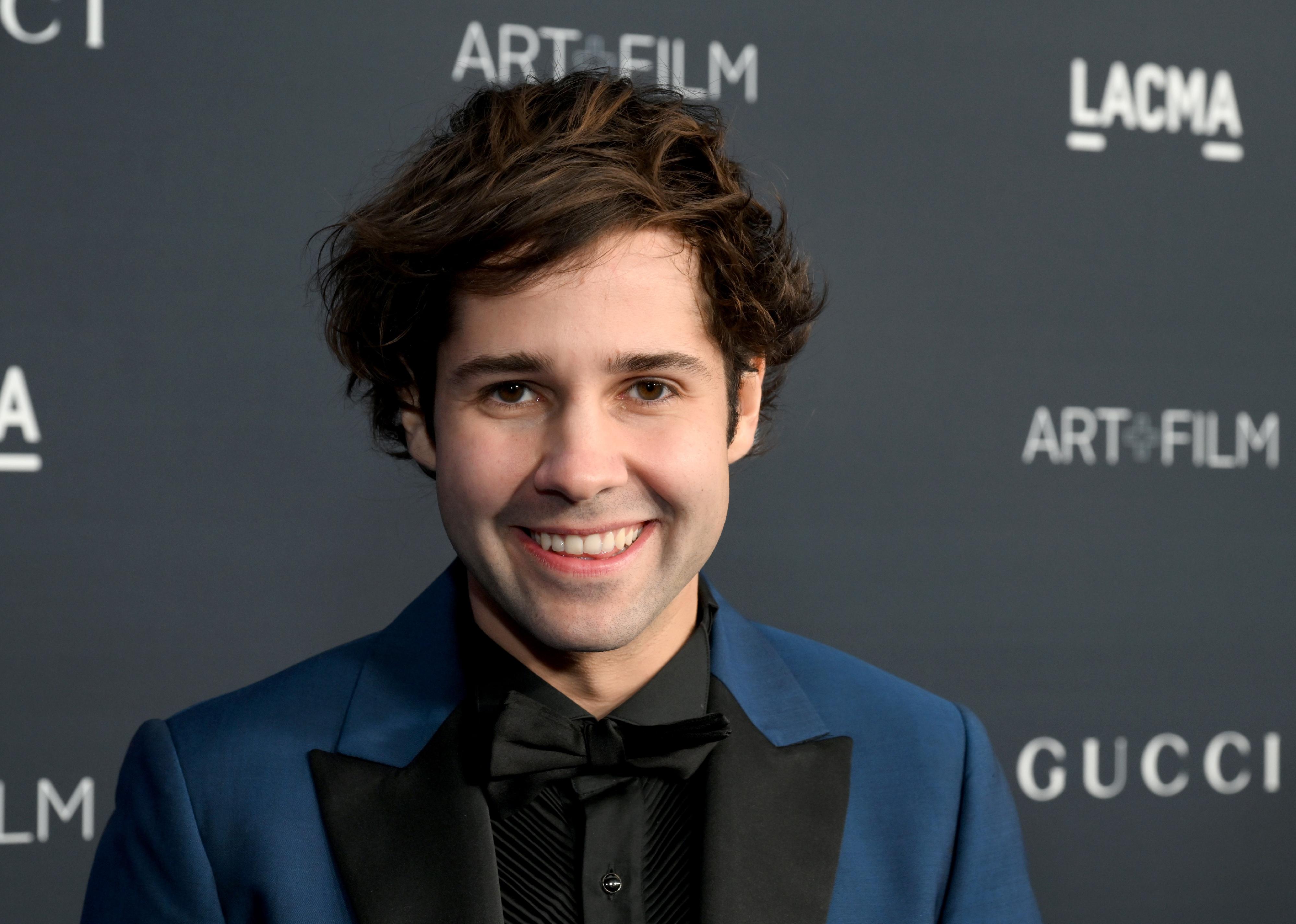 David Dobrik in a blue-and-black suit and bowtie.
