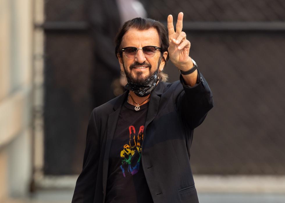 Ringo Starr flashes the peace sign.
