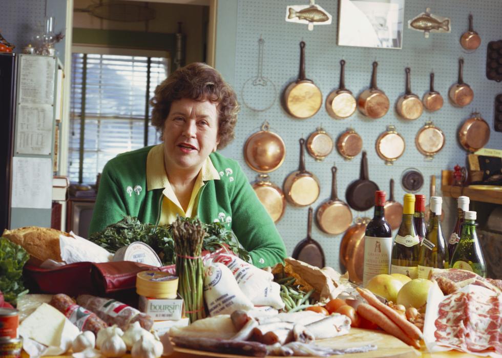 Julia Child poses in her kitchen