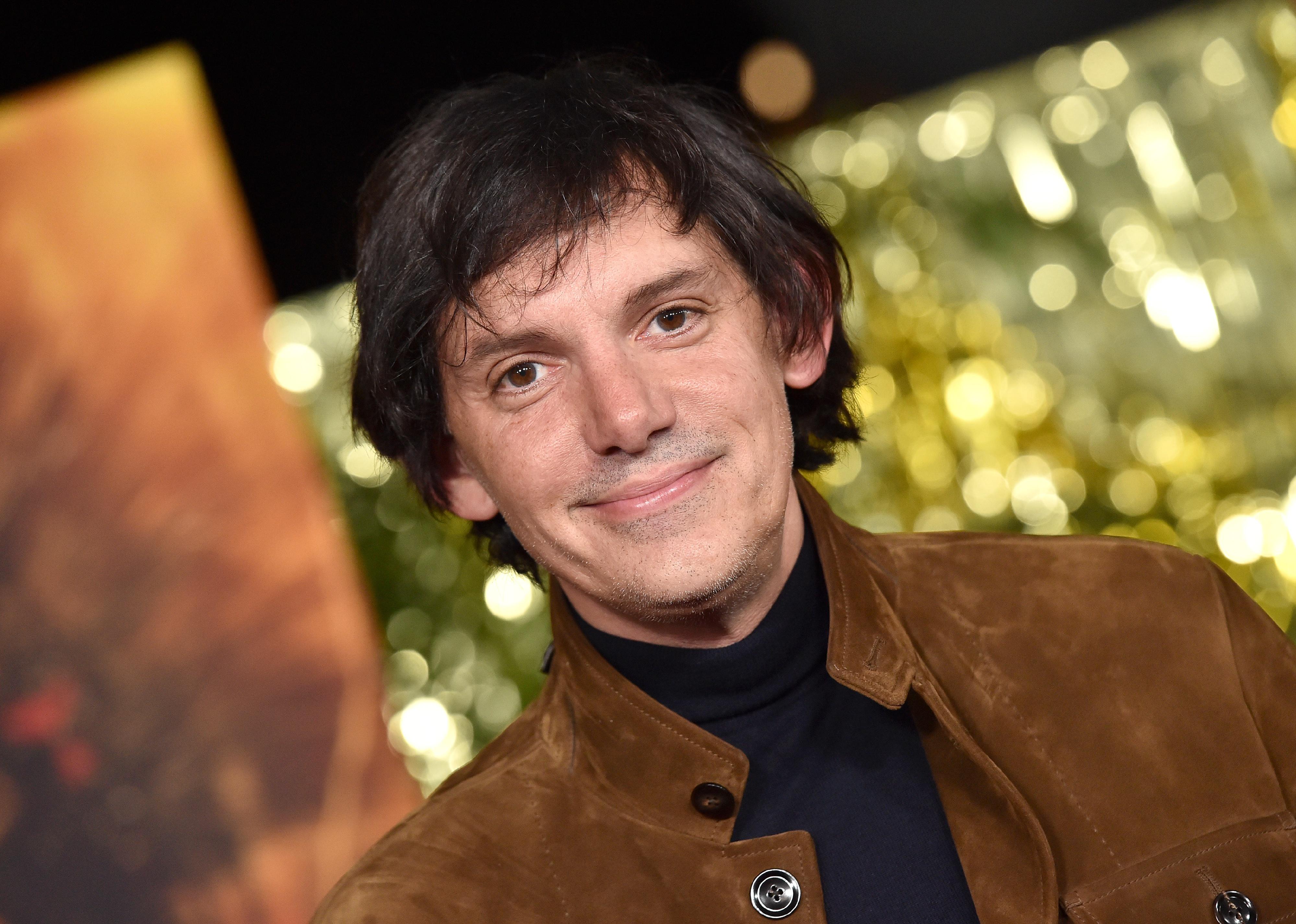 Lukas Haas in a brown suede jacket.