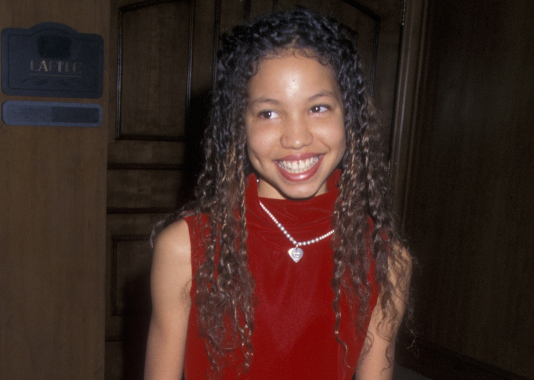 Jurnee Smollett in a red dress.