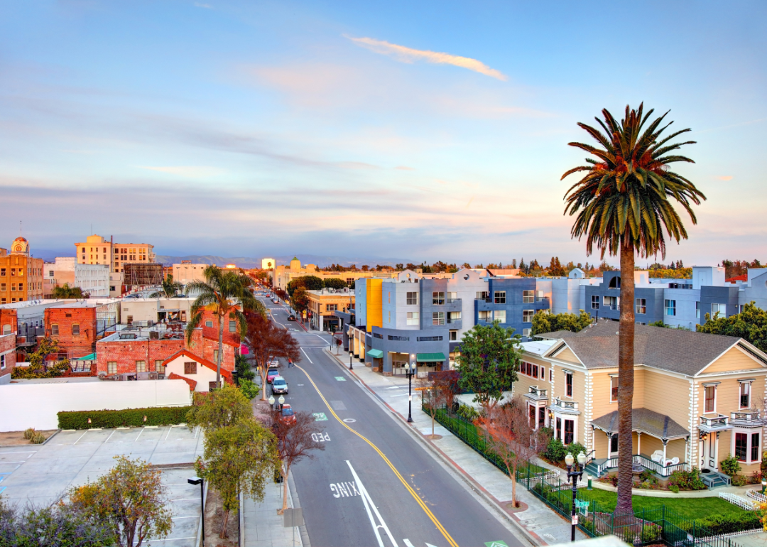 An aerial view of homes and palm trees in a small downtown.