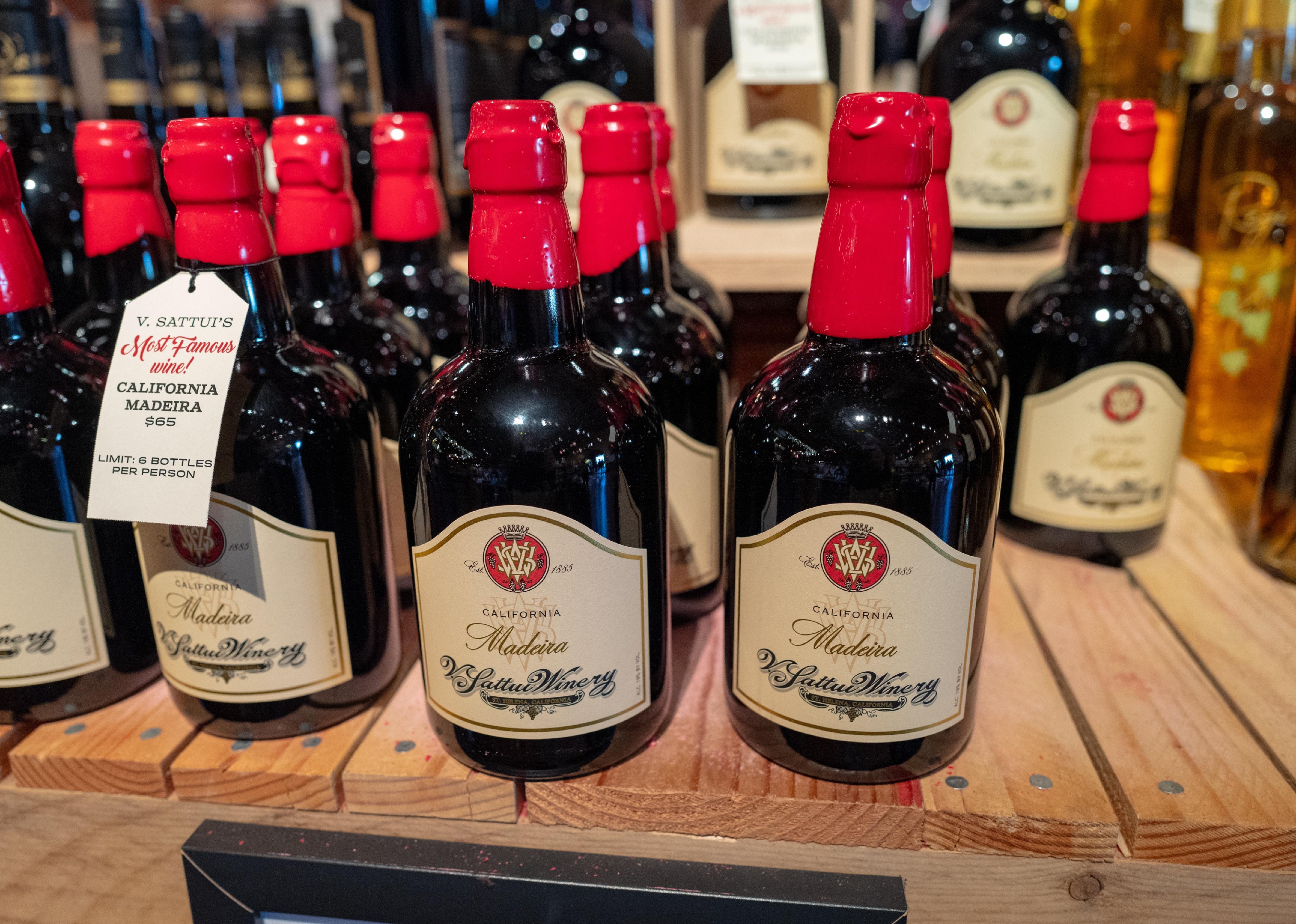 Close up shot of collection of California Madeira wine bottles with red wax tops.