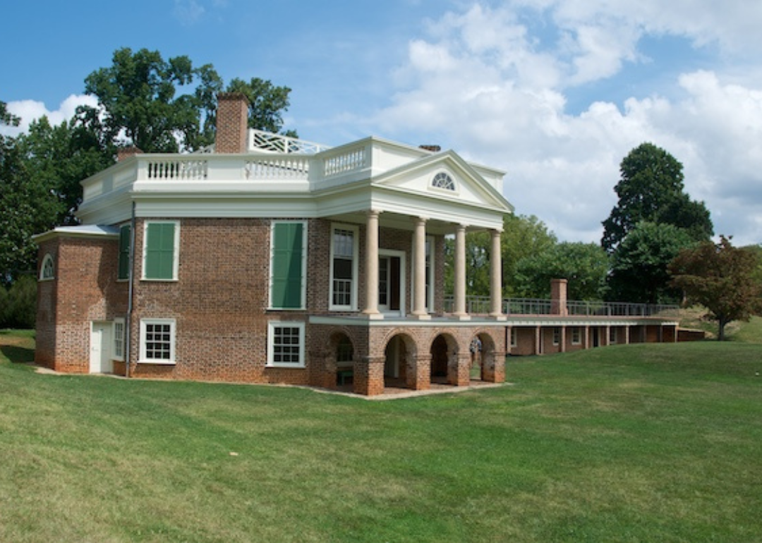 A restored historic brick house with columns.