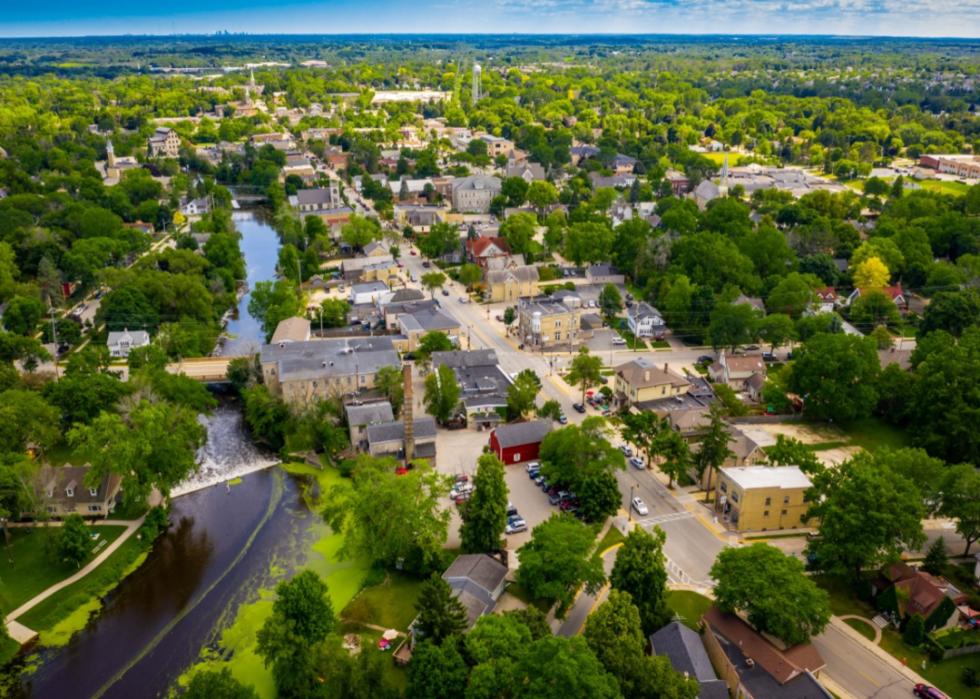 An aerial view of a quaint town with homes on the river.