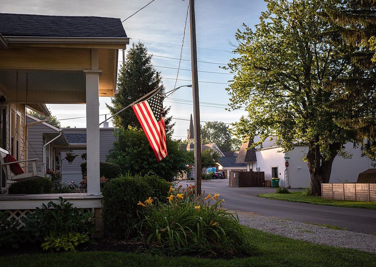 A front porch with an American flag.