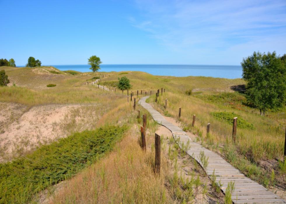 A walkway through sand dunes.