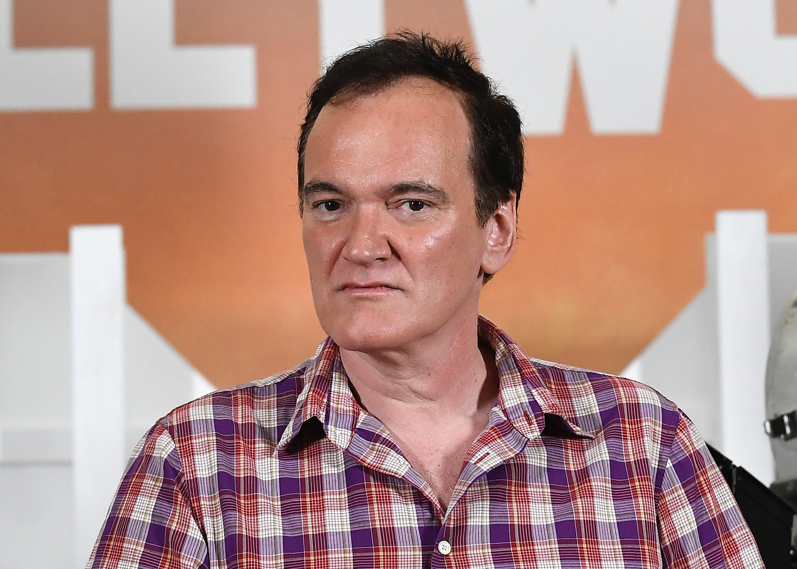 Quentin Tarantino in a plaid shirt.