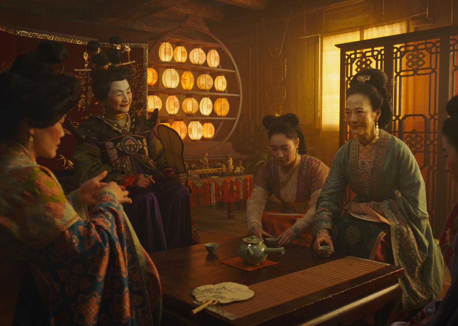 Five women in traditional Chinese dress having tea.
