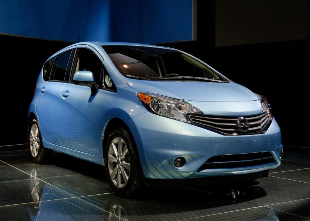 A blue Nissan Versa Note in a showroom.