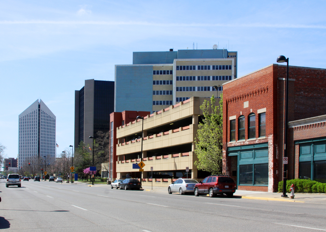 A four lane road lined with small buildings in Wichita.