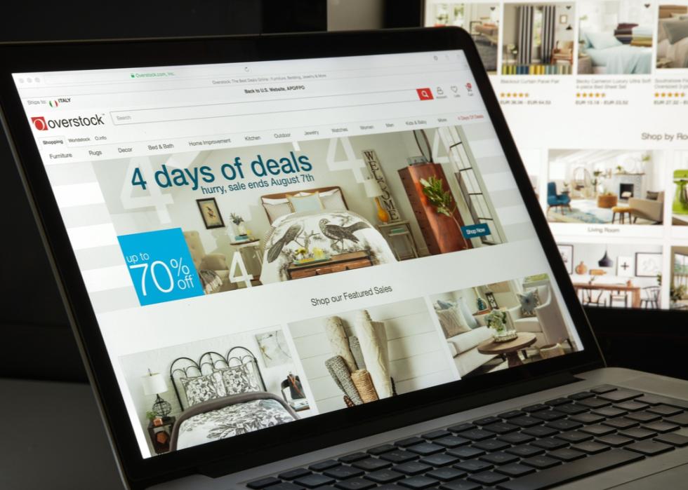 A laptop is open to a page of furniture on Overstock.