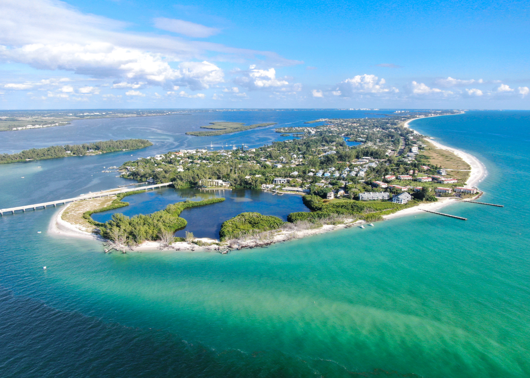 Aerial view of Longboat Key town and beaches surrounded by turquoise water.