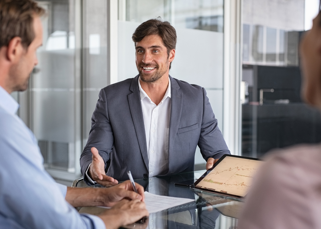 Financial advisor consulting two business people.