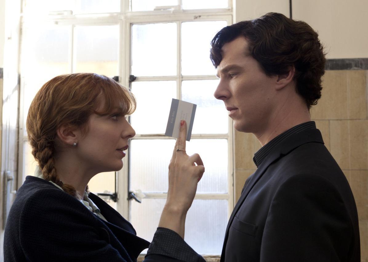 A woman holding up a card to Benedict Cumberbatch.