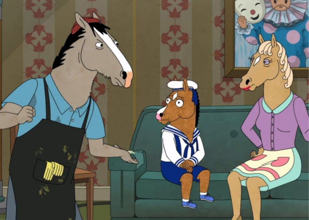 A cartoon of a horse in an apron talking to a baby horse and a woman horse on a couch.