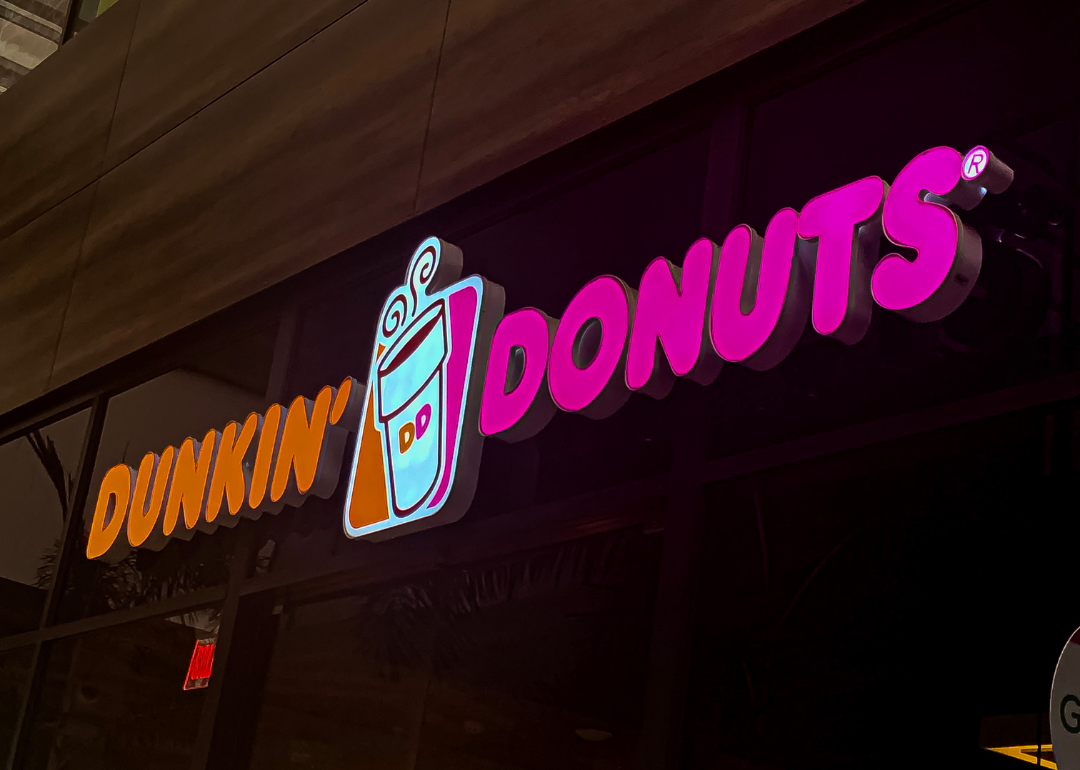 A pink-and-orange neon Dunkin' Donuts sign.