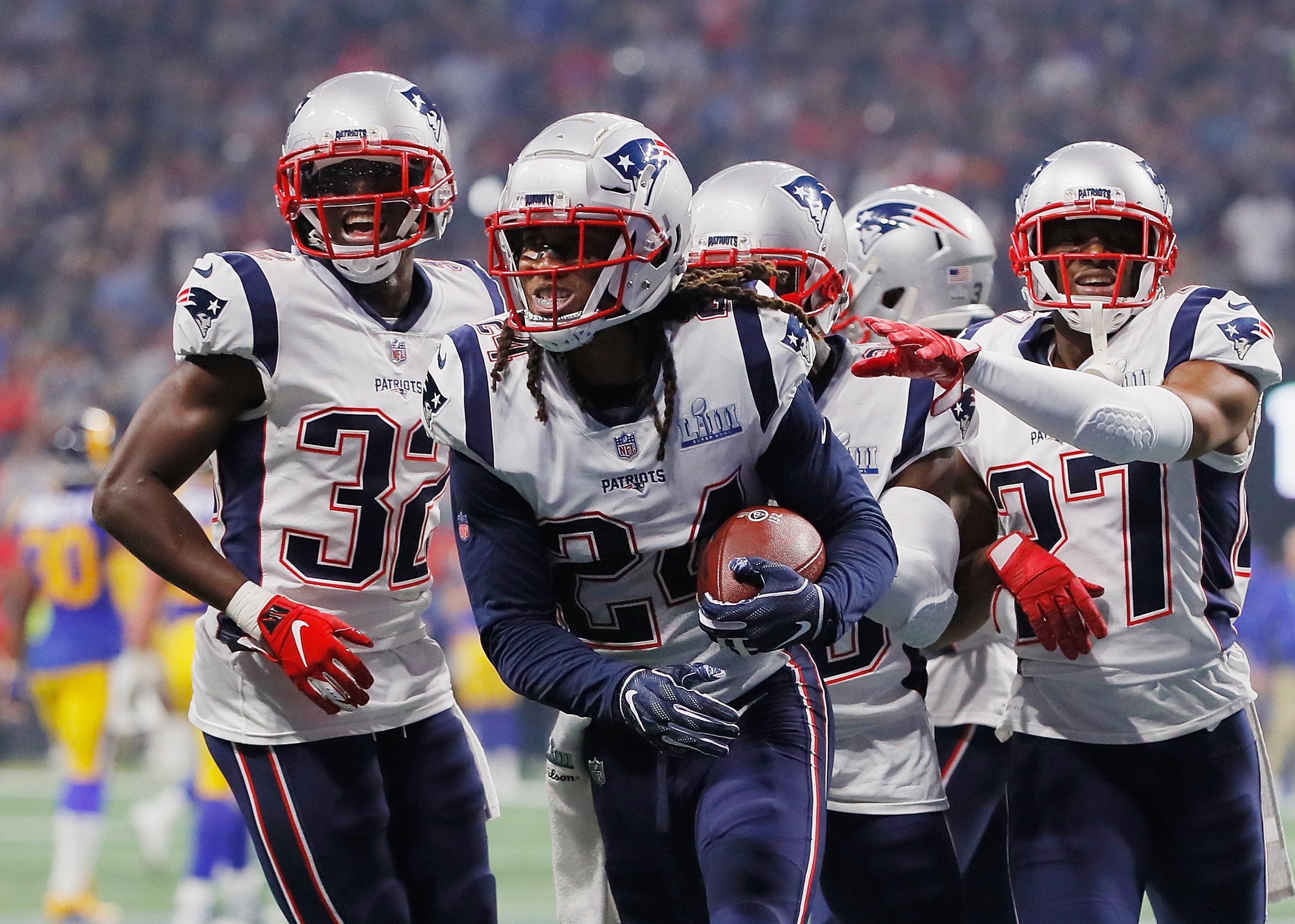 The New England Patriots celebrate with Stephon Gilmore after he made an interception.