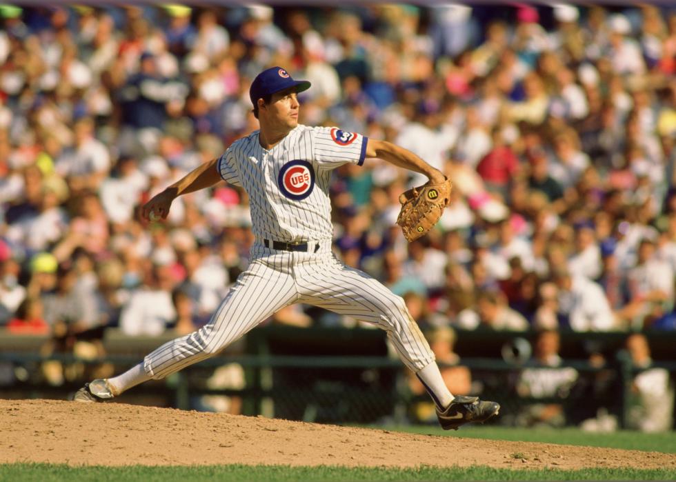 Greg Maddux of the Chicago Cubs pitches during an MLB game.