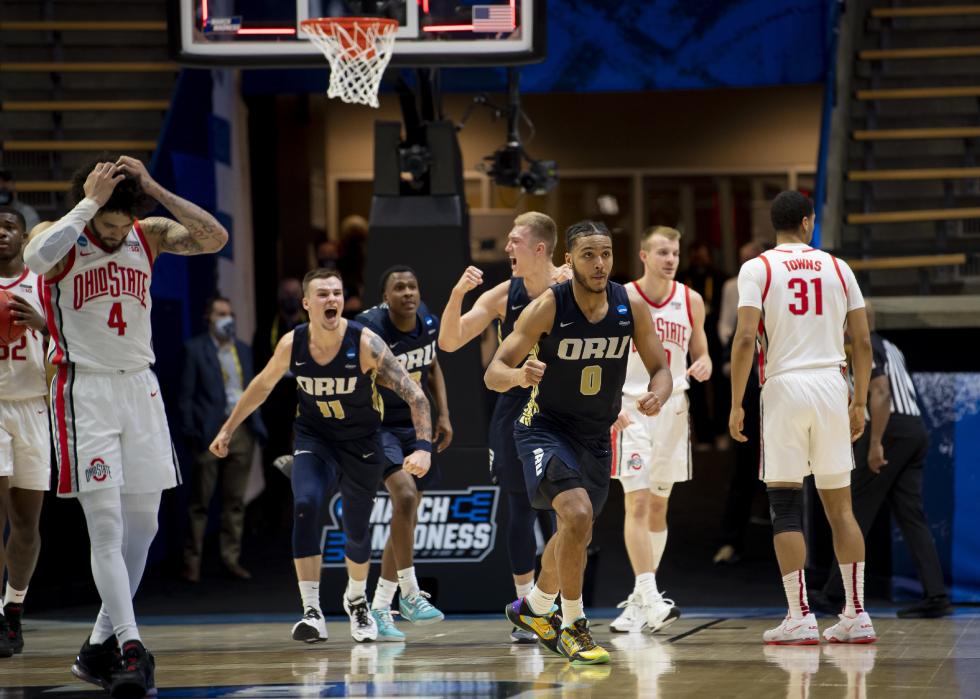  Oral Roberts University players celebrate upsetting Ohio State University in overtime.