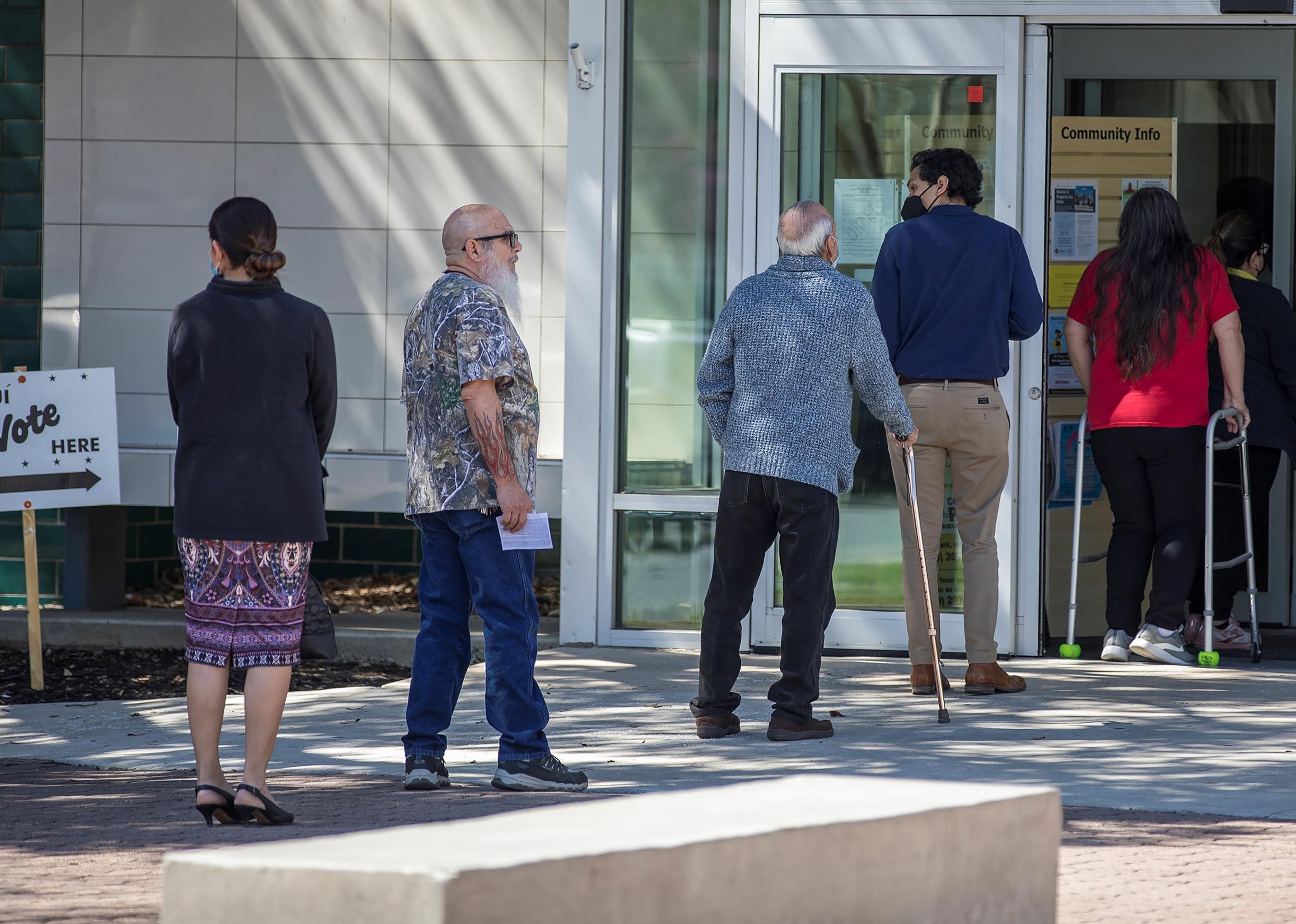 Voters wait in line to cast their ballots in the Texas 2022 primary election in San Antonio, Texas