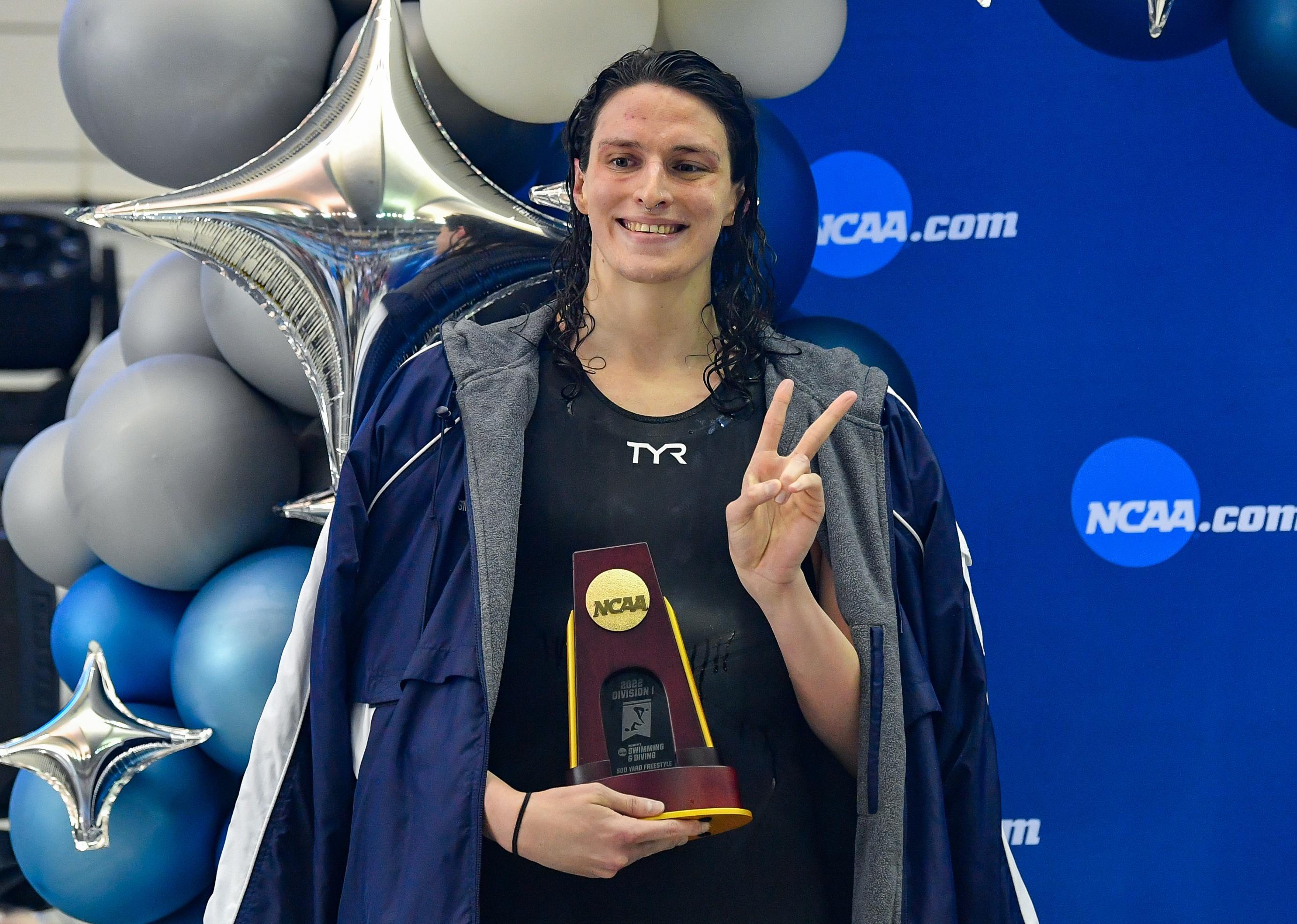 Lia Thomas accepts a trophy for the 500 Freestyle finals during the NCAA Swimming and Diving Championship.