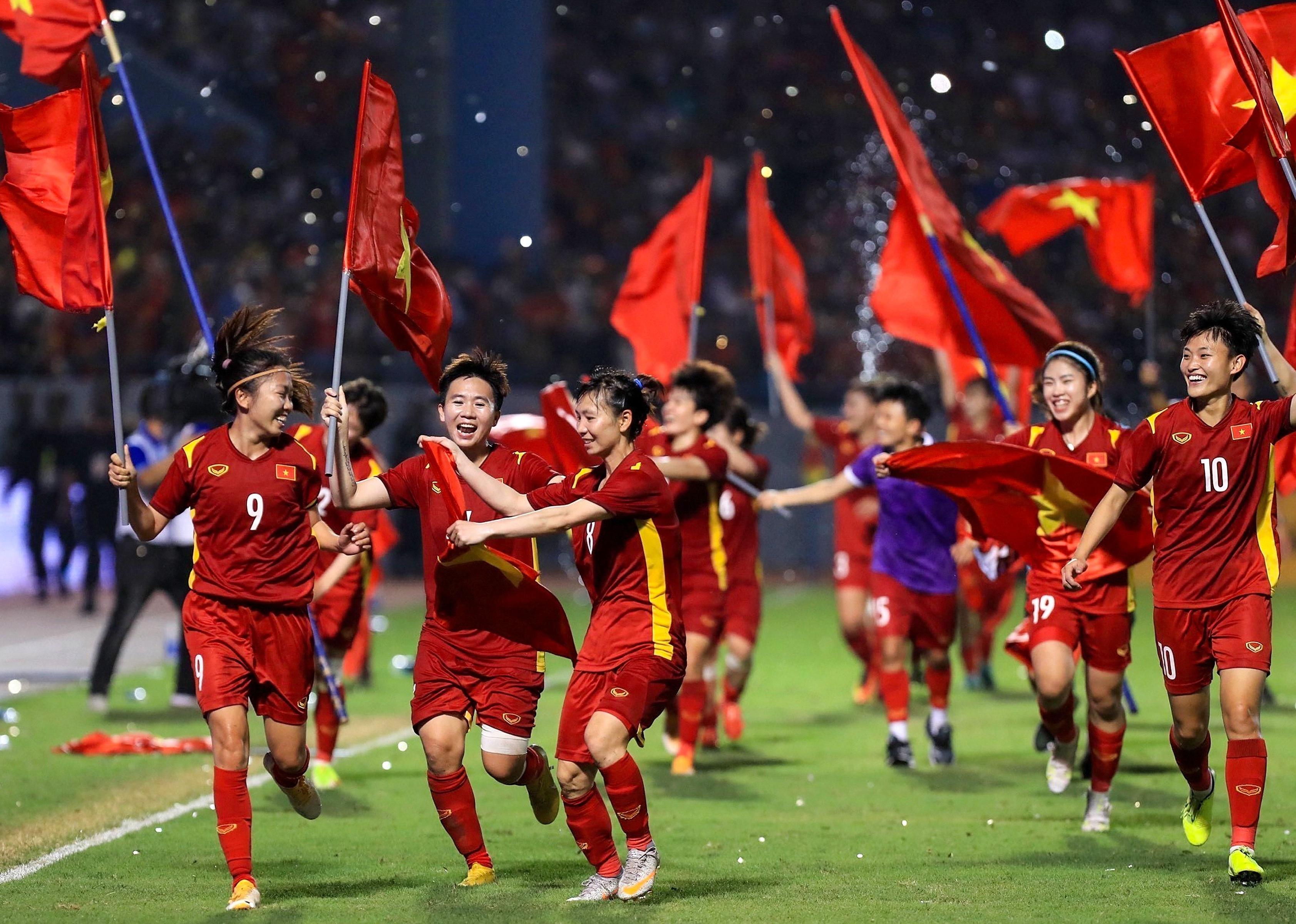Vietnam's players celebrating after beating Thailand in the women's football final match.