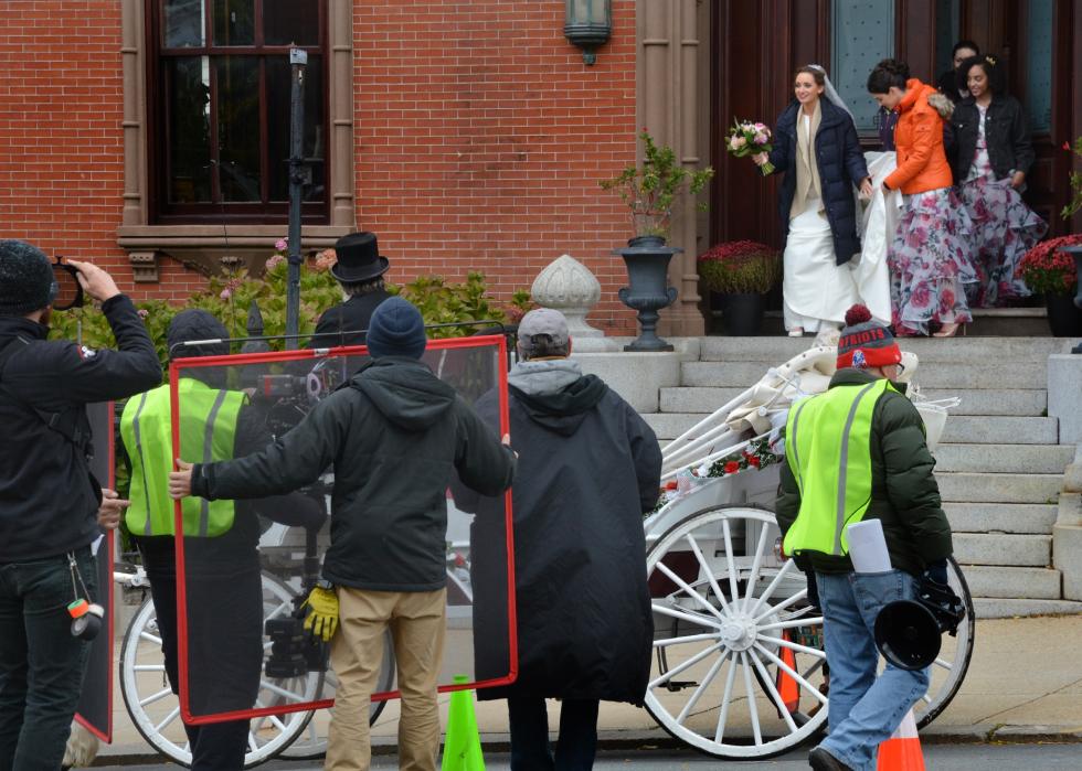 A film crew filiming a scene with a bride outside in Boston